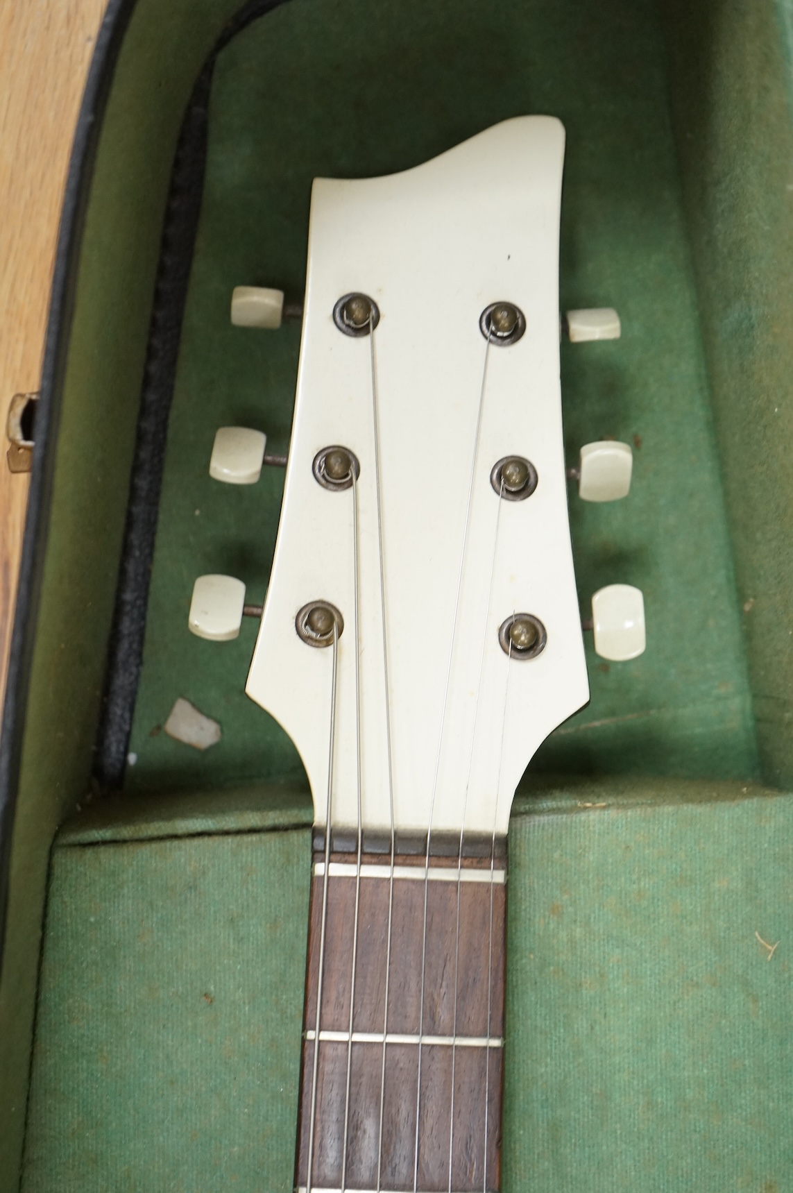 A 1950's Hofner style cut-away acoustic guitar, fitted with a pick up bearing Hofner engraved signature, with hard case.